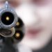 Loaded gun aimed at you, focus on gun barrel (shallow dof)