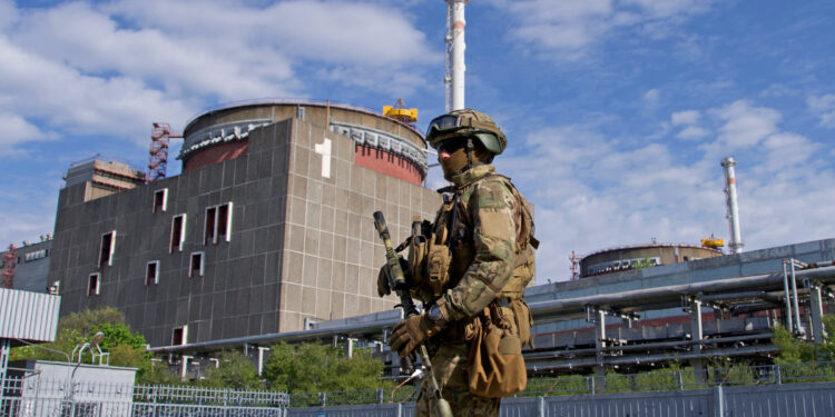 TOPSHOT - A Russian serviceman patrols the territory of the Zaporizhzhia Nuclear Power Station in Energodar on May 1, 2022. - The Zaporizhzhia Nuclear Power Station in southeastern Ukraine is the largest nuclear power plant in Europe and among the 10 largest in the world. 
 *EDITOR'S NOTE: This picture was taken during a media trip organised by the Russian army.* (Photo by Andrey BORODULIN / AFP) (Photo by ANDREY BORODULIN/AFP via Getty Images)