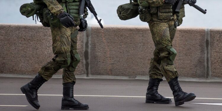 Russian soldiers walk alone an embankment at a Russian Defense Ministry building showing themselves prior to a concert for the all-Russian festival "Russian Army in 2016" in Moscow, Russia, Saturday, Sept. 17, 2016.  The military festival features army bands, dancers and singers. (AP Photo/Alexander Zemlianichenko)