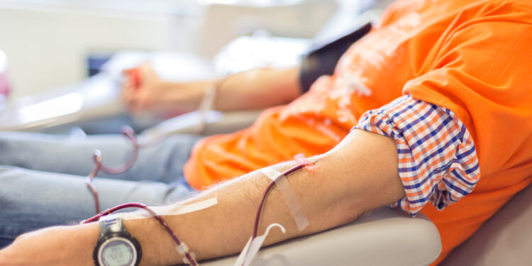 Blood donor at donation with a bouncy ball holding in hand.